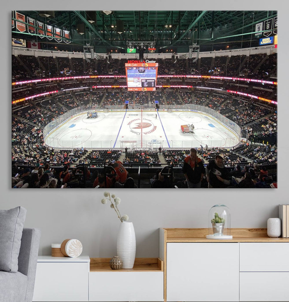 The wall art of the Honda Center California Anaheim Ducks Ice Hockey Stadium features a depiction of the rink and scoreboard from the perspective of the upper deck.