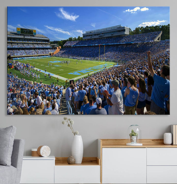 A gallery-quality canvas wall art print featuring the University of North Carolina Tar Heels Football Team and Chapel Hill's Kenan Memorial Stadium adorns the cafe wall.