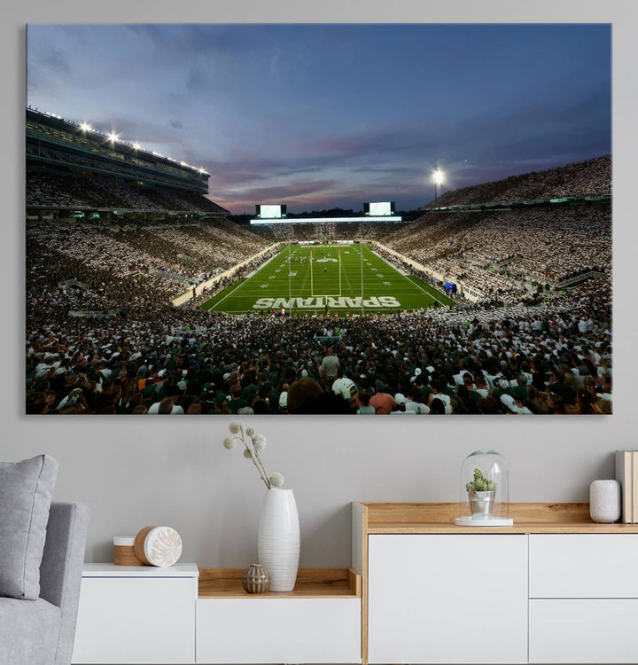 Wall art featuring a stadium at dusk with full stands—ideal for the Michigan State Spartans Football Team Canvas Print.