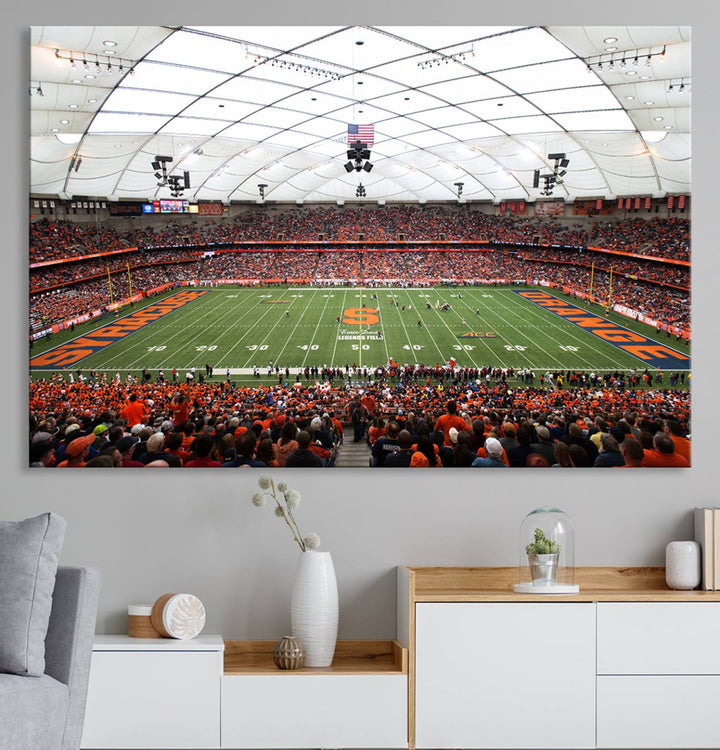 Fans fill the Syracuse JMA Wireless Dome, highlighted in orange and blue under a vaulted roof on this premium canvas print of the scene.