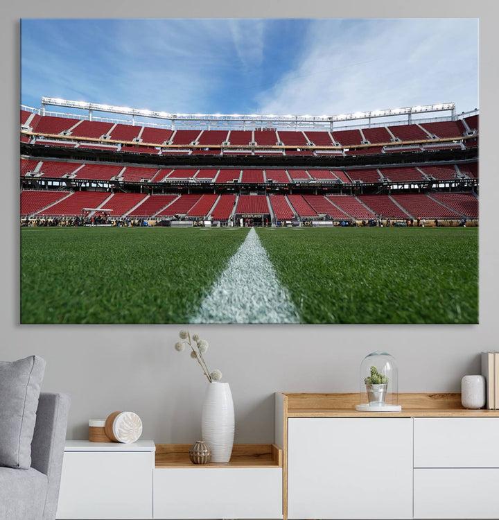 A canvas print of the University of Tulsa Golden Hurricane showcases H.A. Chapman Stadiums football field and red seats against a backdrop of a blue sky.