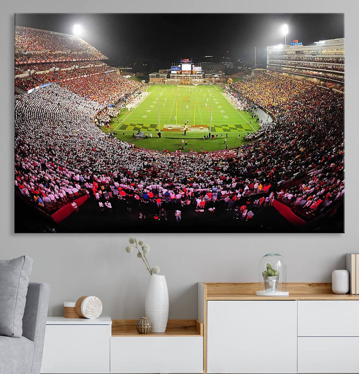 The Maryland Terrapins Football Wall Art Canvas showcases a packed SECU Stadium at night with a bright field and cheering fans.