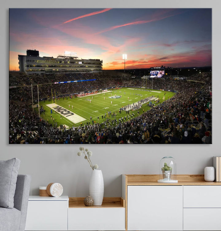 This wall art canvas print captures UCONN Huskies fans energizing a sunset scene at East Hartfords Pratt & Whitney Stadium.