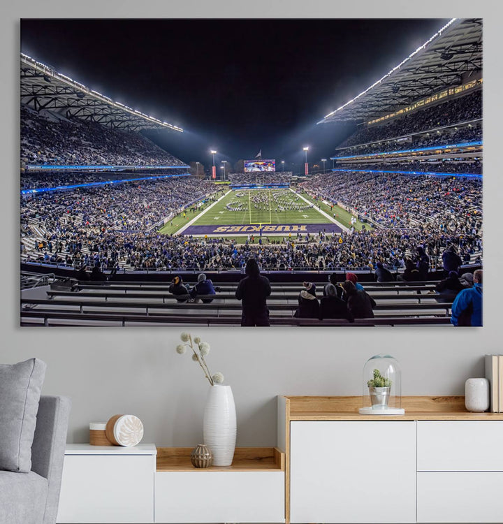 A canvas print titled The University of Washington Huskies Football depicts a packed Husky Stadium at night, as seen from the stands.