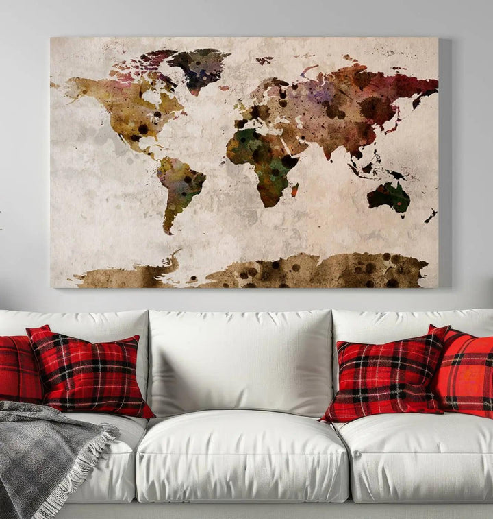 A Watercolor World Map Canvas Print, wrapped in an elegant gallery style, hangs on the wall.