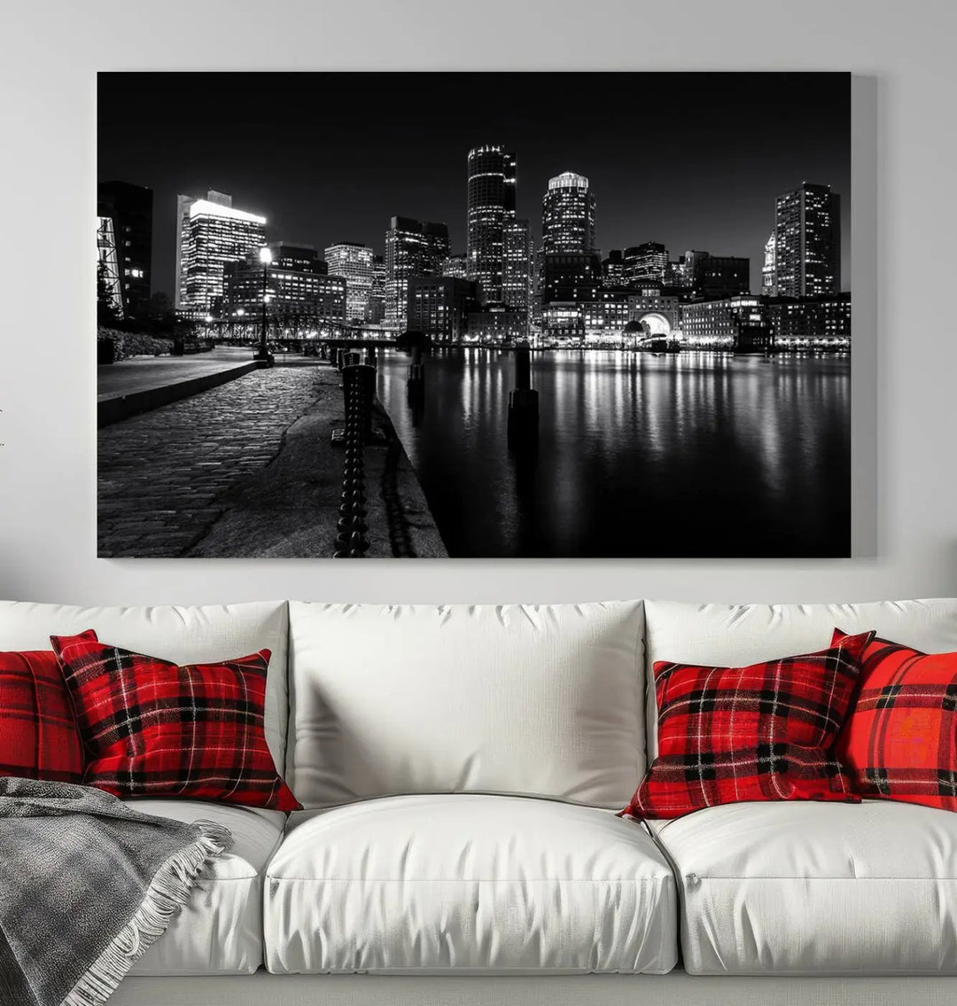 The Boston City Lights Skyline Black and White Wall Art Cityscape Canvas Print portrays a triptych of the city skyline at night reflecting on a calm river. This museum-quality canvas features UV-protective finishes to preserve its timeless allure.