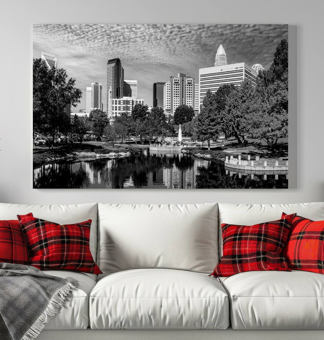 The living room features a captivating triptych titled "Charlotte City Cloudy Skyline Black and White Wall Art Cityscape Canvas Print," crafted on museum-quality canvas with UV-protective coating. Modern decor accentuates the dynamic scene.