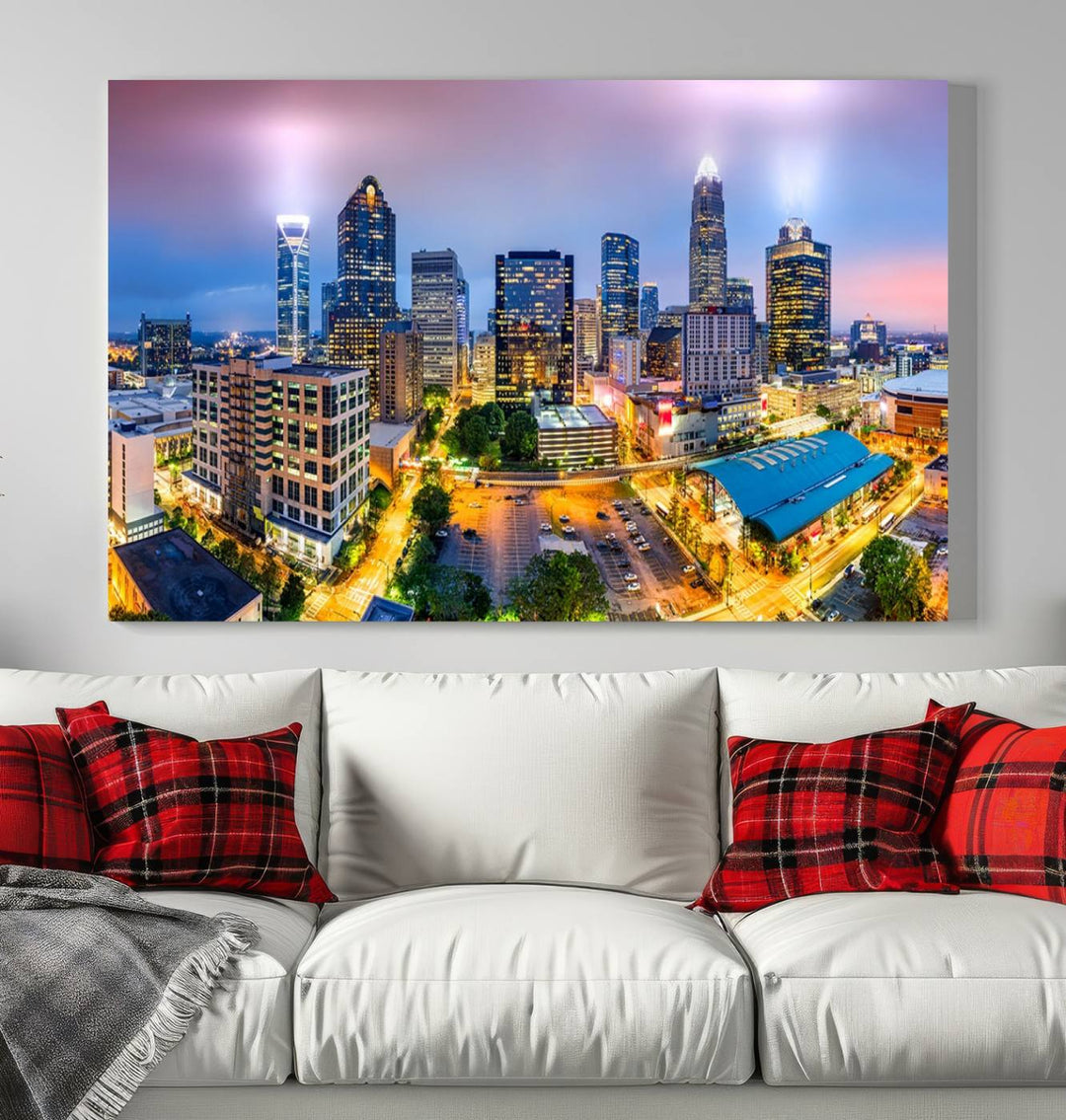 The living room features three large pieces of the *Charlotte City Lights Sunset Purple Skyline Cityscape View Wall Art Canvas Print*. Crafted on gallery-wrapped, museum-quality canvas with UV-protective coating, they grace the wall and add an artistic flair to the space.