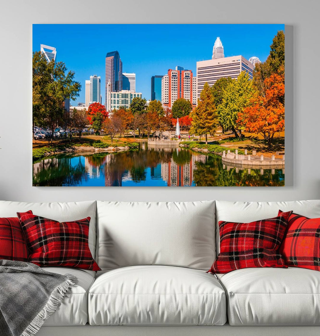 The Charlotte City Park at Fall Skyline Cityscape View wall art canvas print features a city panorama with a park and lake accented by autumn trees. It is mounted on museum-quality canvas with UV-protective coating and decorates the space.