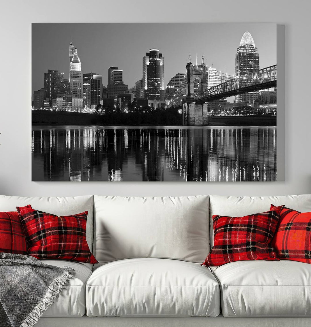 The wall showcases a ready-to-hang triptych of the Cincinnati City Lights Skyline in black and white, printed on museum-quality canvas.