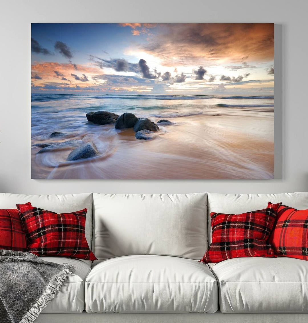 The "Serene Weather On The Beach Wall Art Canvas Print," featuring a tranquil beach scene with rocks and waves, is ready to hang and enjoy.