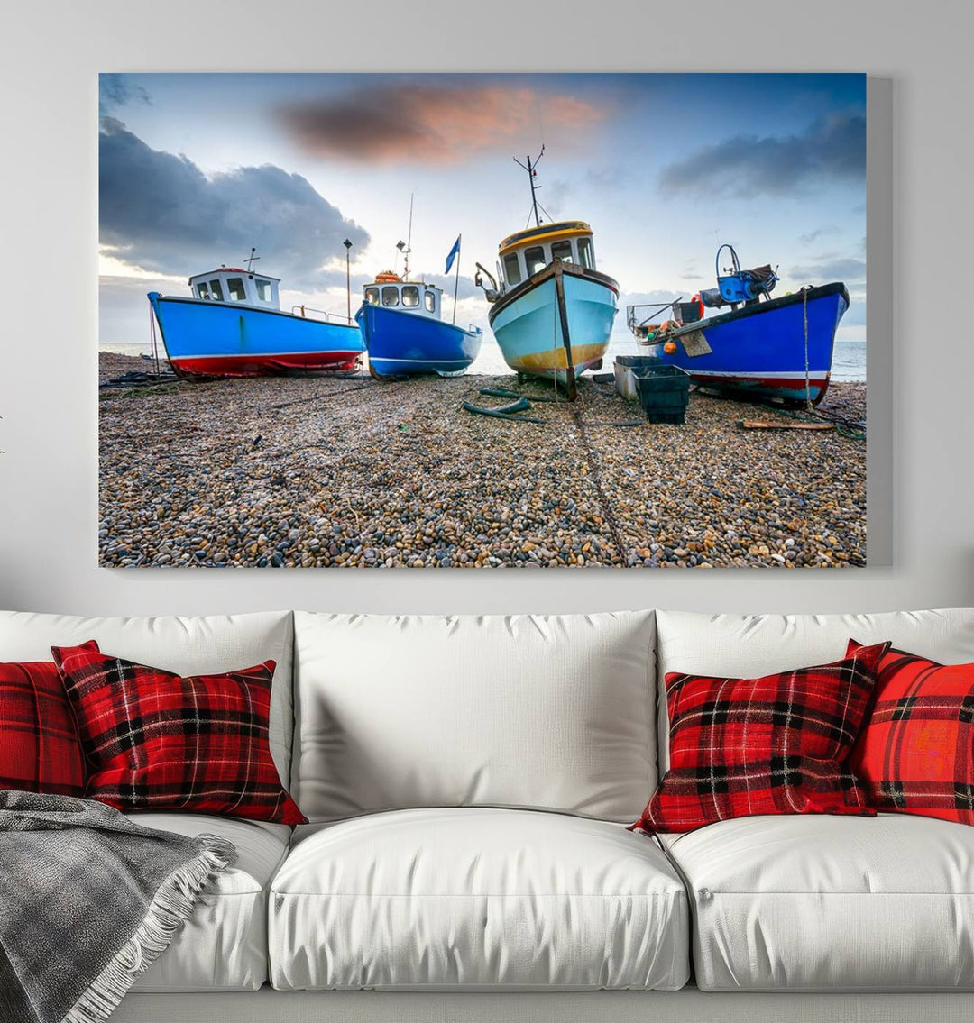 The "Big Boats On The Beach Wall Art Canvas Print" is a stunning piece featuring three museum-quality panels depicting fishing boats on a pebbled shore. Ready to hang and featuring UV-protective coating, it serves as an elegant addition to your home décor.