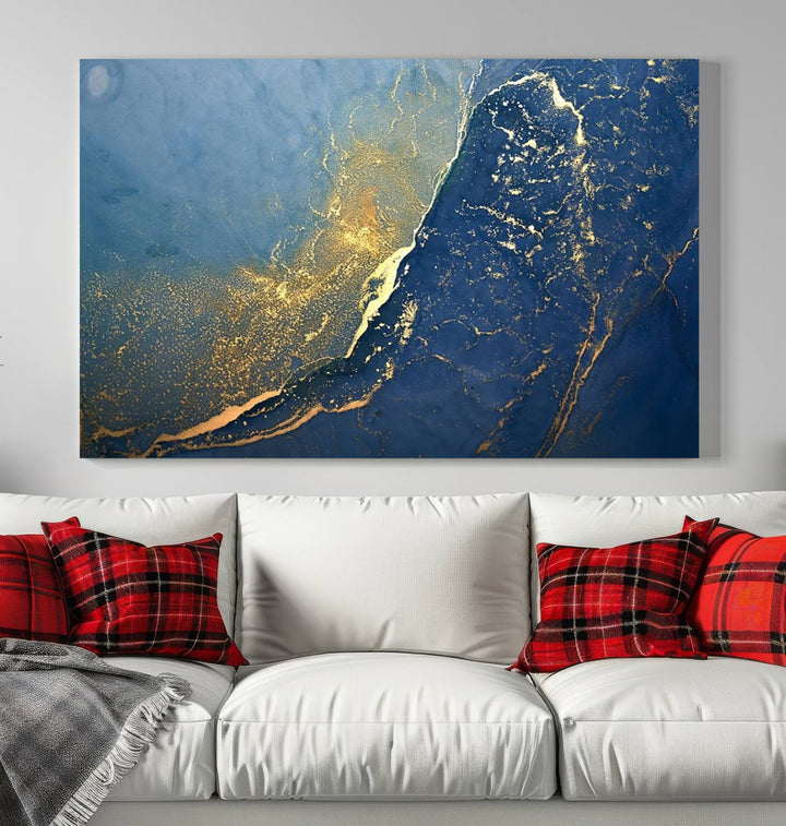 The Navy Blue Yellow Twinkle Wall Art Canvas Print, featuring an abstract design in gold and blue, enhances a modern living room as it adorns a white wall with its gallery-wrapped, museum-quality canvases for an exquisite touch.