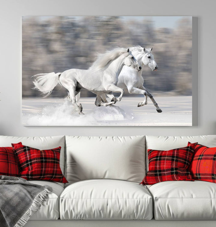 The "All The White Horses Wall Art Canvas Print" depicts a triptych of galloping white horses across a snowy landscape. These museum-quality canvases come with a UV-protective coating to maintain their stunning appearance over time.