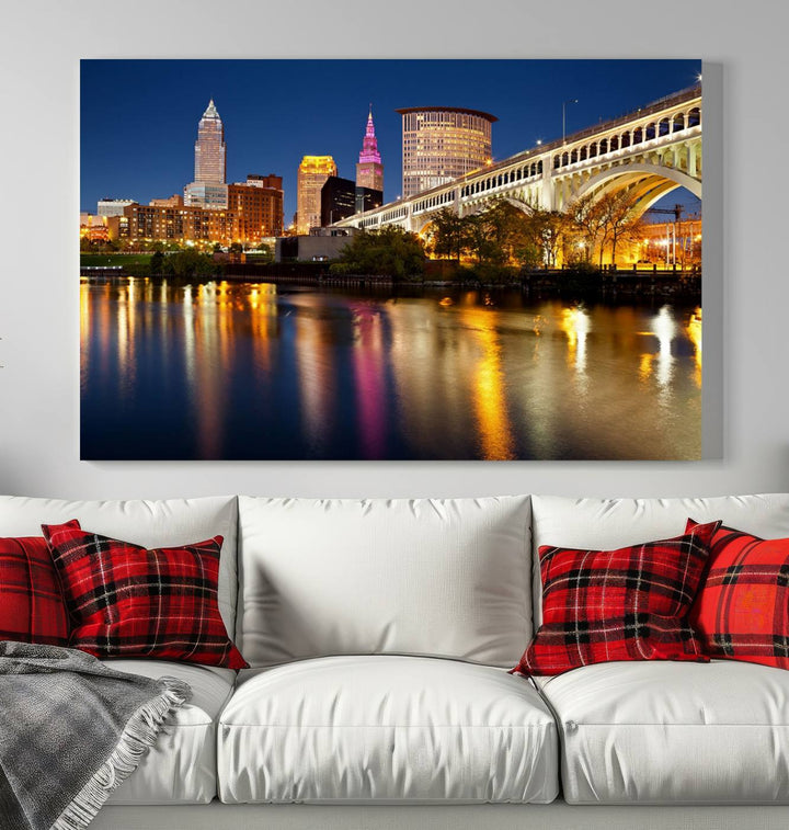 The "Cleveland Night Skyline Wall Art City Cityscape Canvas Print" is a striking feature in the room, showcasing a city skyline with a bridge reflecting in a river. Displayed on museum-quality canvas, it offers enduring beauty.