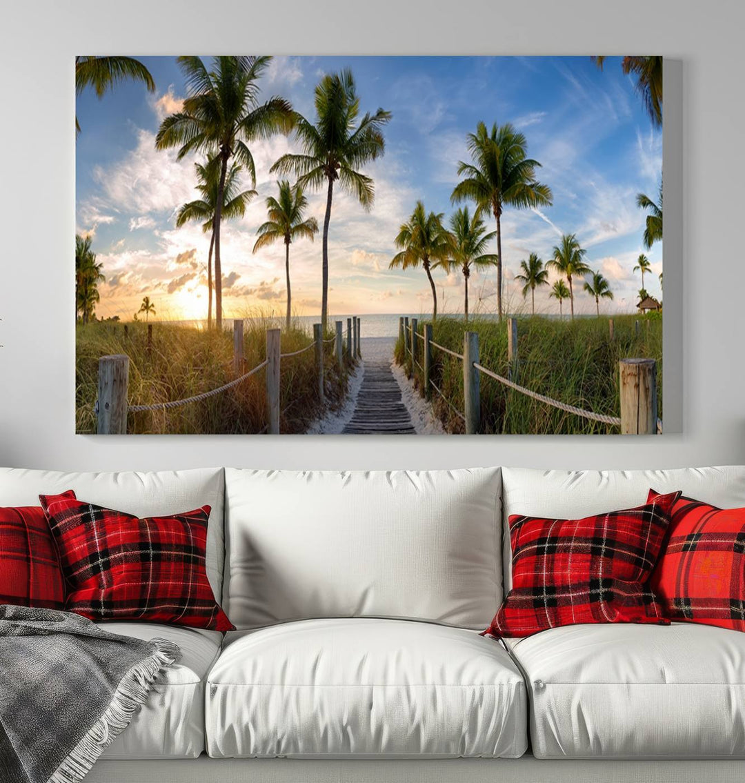 A museum-quality canvas featuring a panoramic view of the footbridge leading to Smathers Beach at sunrise in Key West, Florida, complete with UV-protective coating, hangs prominently.