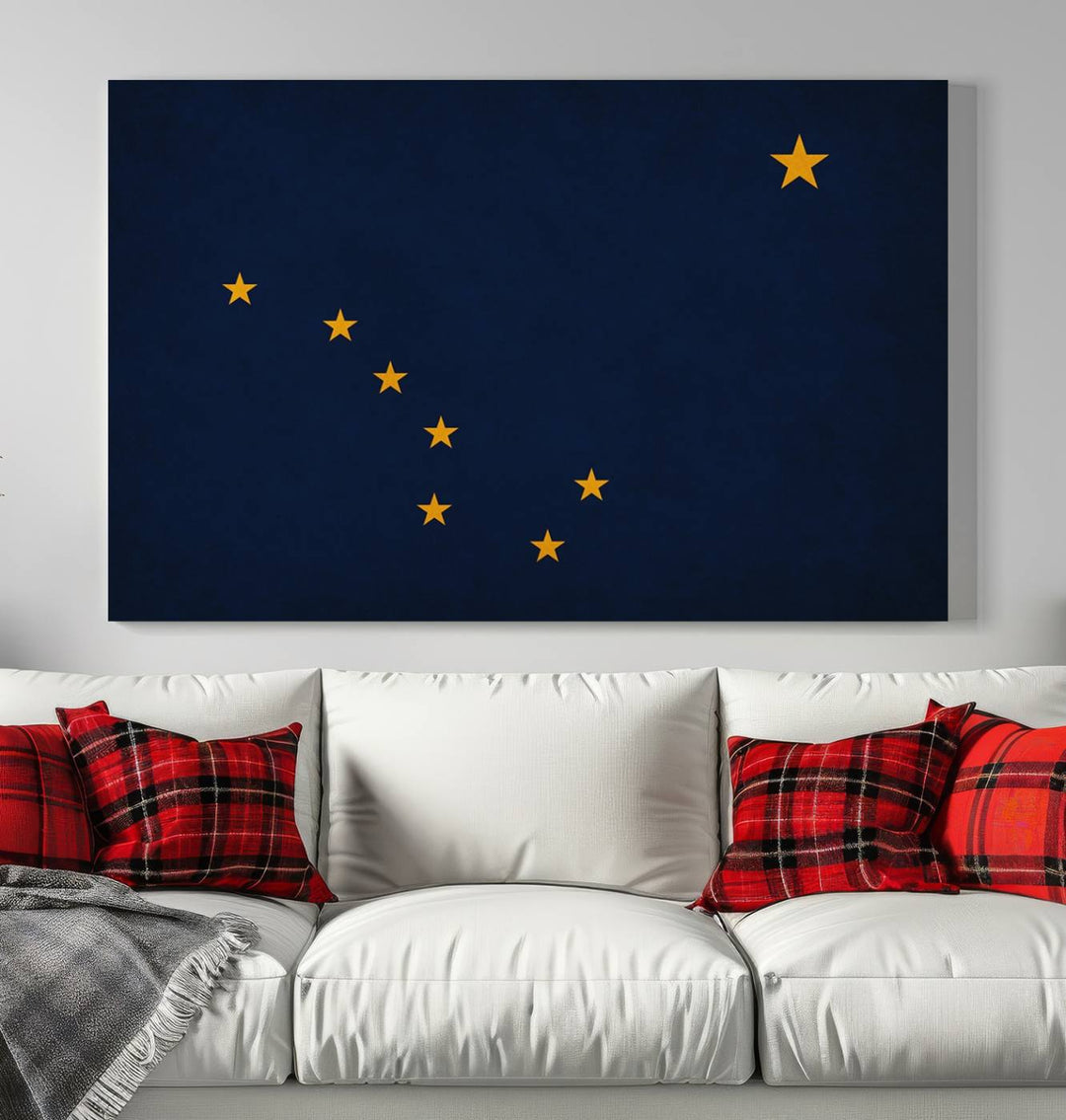 A contemporary living room featuring a triptych artwork of stars on a navy background, accentuated by the striking Alaska States Flag Wall Art Canvas Print.