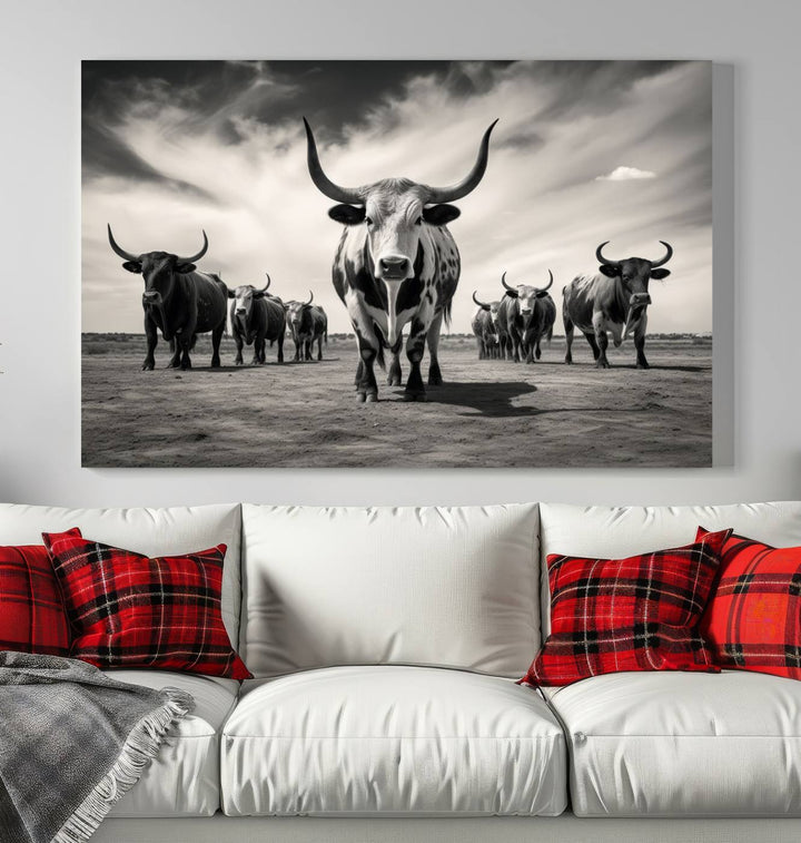 The Black and White Longhorn Cattle Wall Art, featuring a three-panel display of cowboy Western longhorns walking toward the viewer, enhances your space with its striking presence, adding a touch of Western decor.