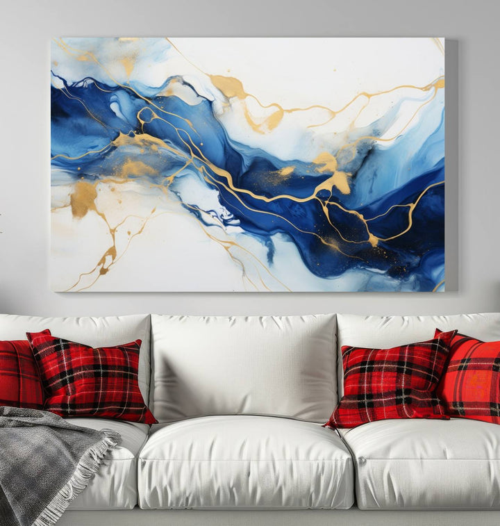 The Blue Abstract Wall Art is displayed as a triptych on museum-quality canvas, showcasing a blue and gold abstract design. The artwork includes a UV-protective coating to maintain its vibrancy and comes with the benefit of free shipping.