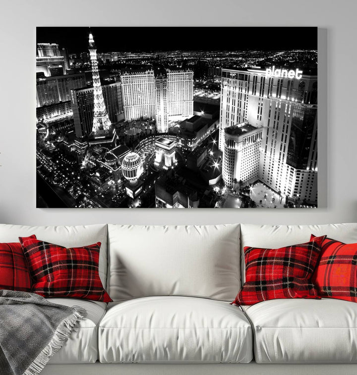 The Las Vegas Wall Art Canvas Print is a black and white triptych that showcases a city skyline at night. Crafted on museum-quality canvas with a UV-protective coating, it serves as an elegant and ready-to-hang focal point in the room.