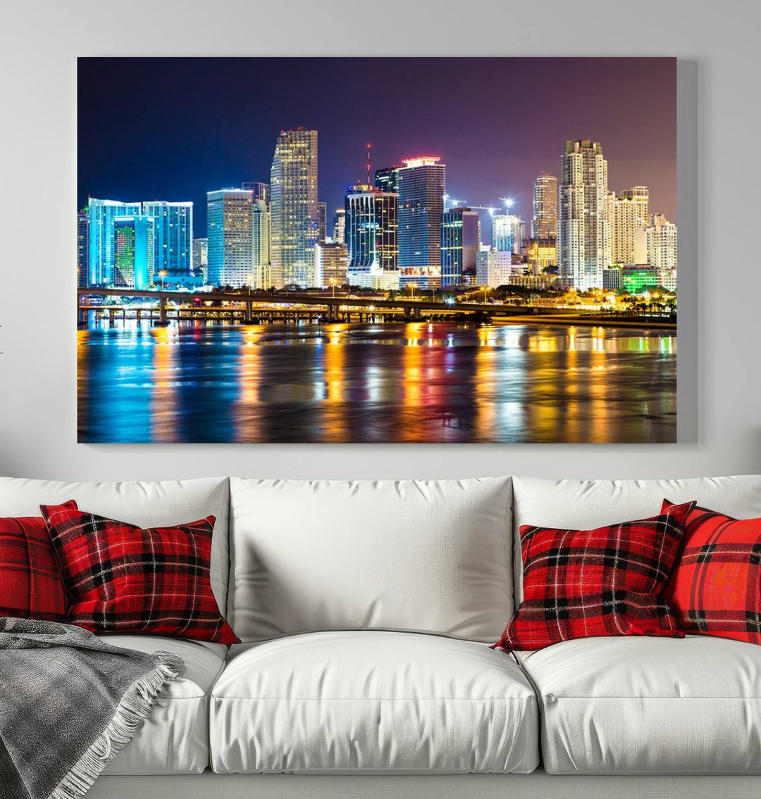 The Wall Art MIAMI Canvas Print features a stunning triptych of a city skyline at night, with vibrant lights reflecting on the water. This gallery-wrapped piece on museum-quality canvas delivers an exquisite finish.