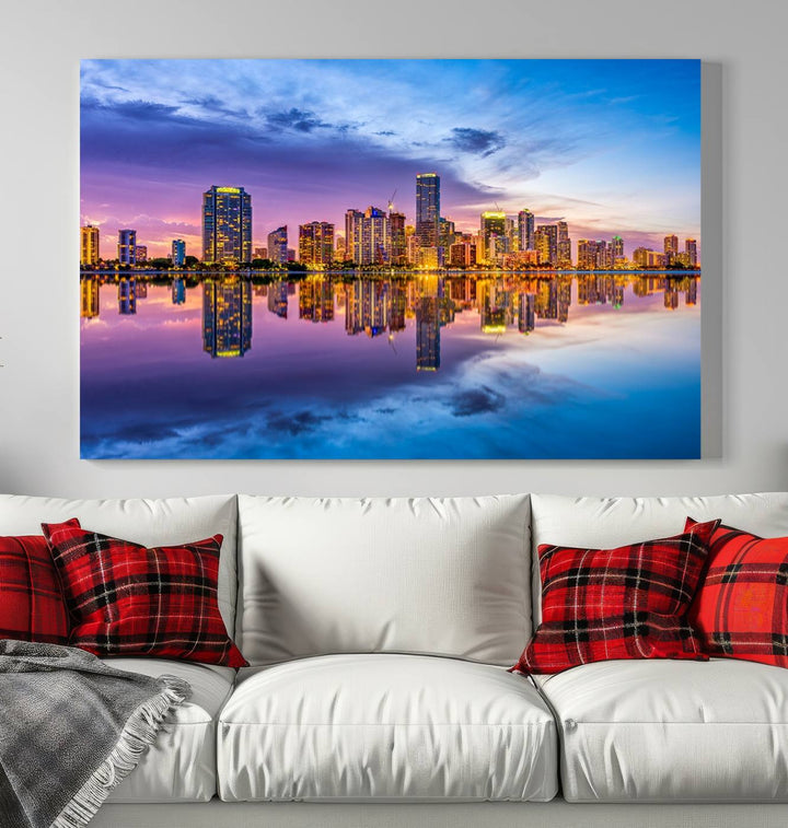 The Miami City Wall Art Canvas Print, featuring a three-panel depiction of a city skyline at sunset reflected in water, beautifully enhances the wall. Made with museum-quality canvas and a UV-protective coating, it comes ready to hang.