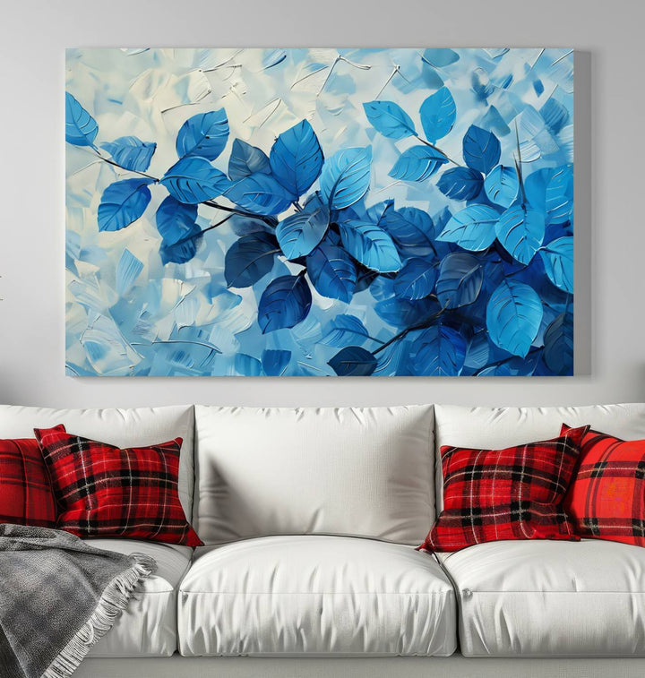 The contemporary living room is highlighted by the Abstract Blue Leaf Wall Art Canvas Print on the wall. The hand-assembled framed art enhances the room's vibrant decor, crafting a gallery-worthy ambience.