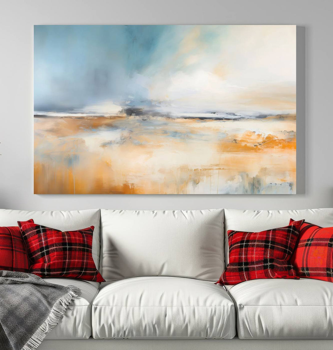 The Abstract Landscape Wall Art Canvas Print, featuring warm tones of orange and blue, is displayed on a dark wall.