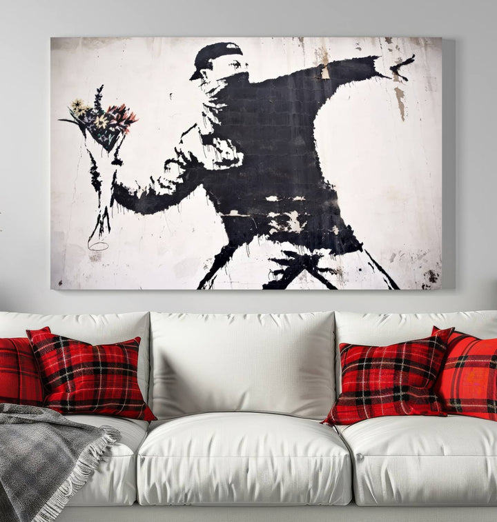 The living room features a split-panel art piece named "Banksy Flower Throw Graffiti Street Wall Art Canvas Print," gallery wrapped on museum-quality polycotton canvas and accentuated by modern decor elements.