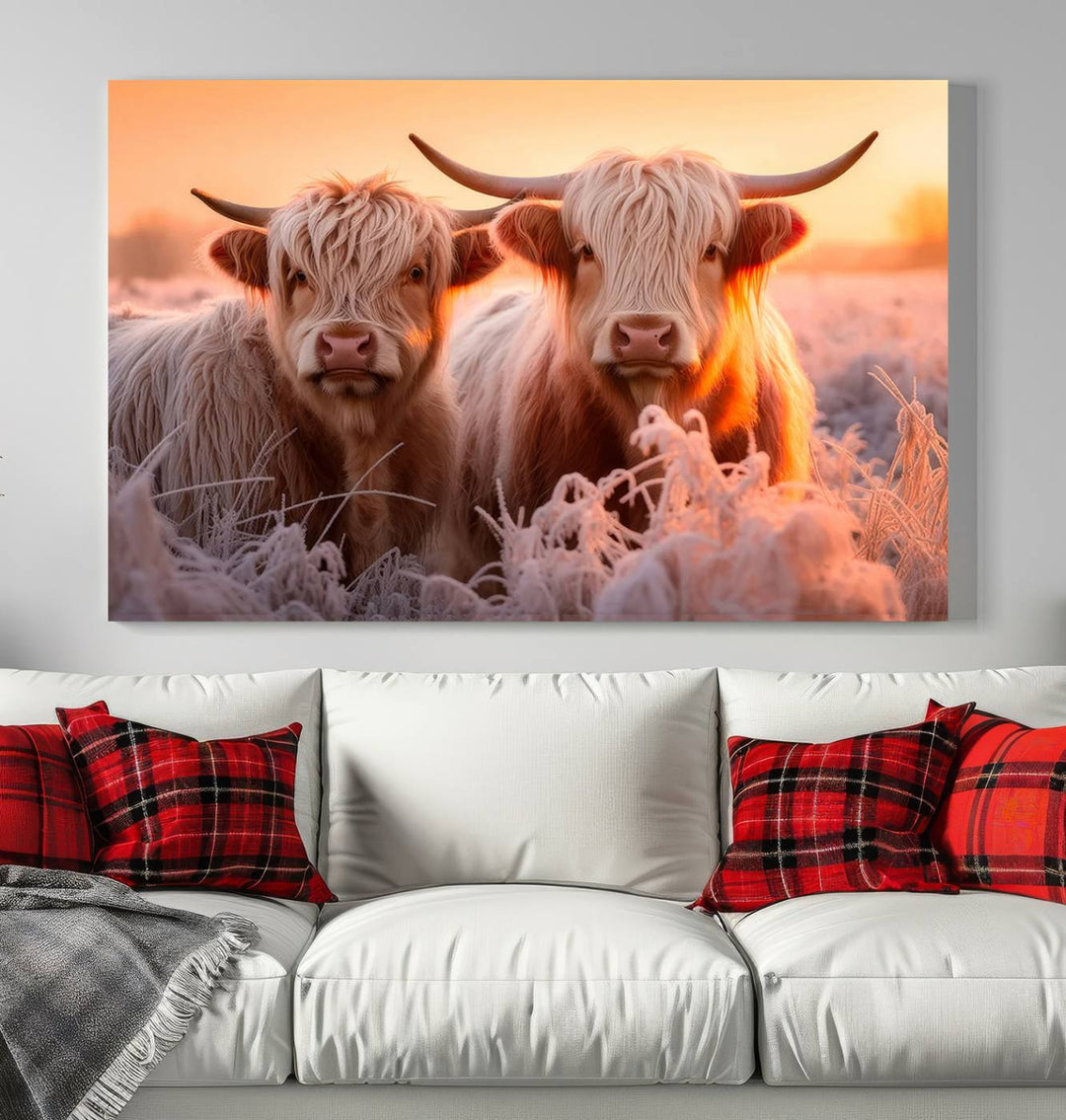 The "Highland Cows at Sunrise Wall Art Canvas Set" beautifully captures a serene and rustic farmhouse aesthetic, portraying two Highland cows in a frosty landscape at sunrise.