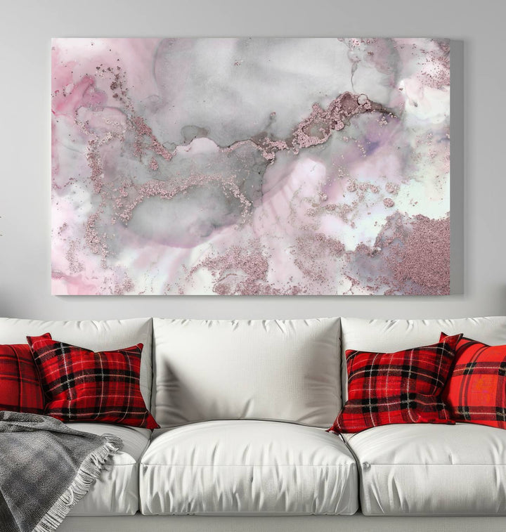 The Rose Marble Abstract Wall Art Canvas Print is a stunning triptych that showcases pink and gray tones, elegantly presented on a dark wall.