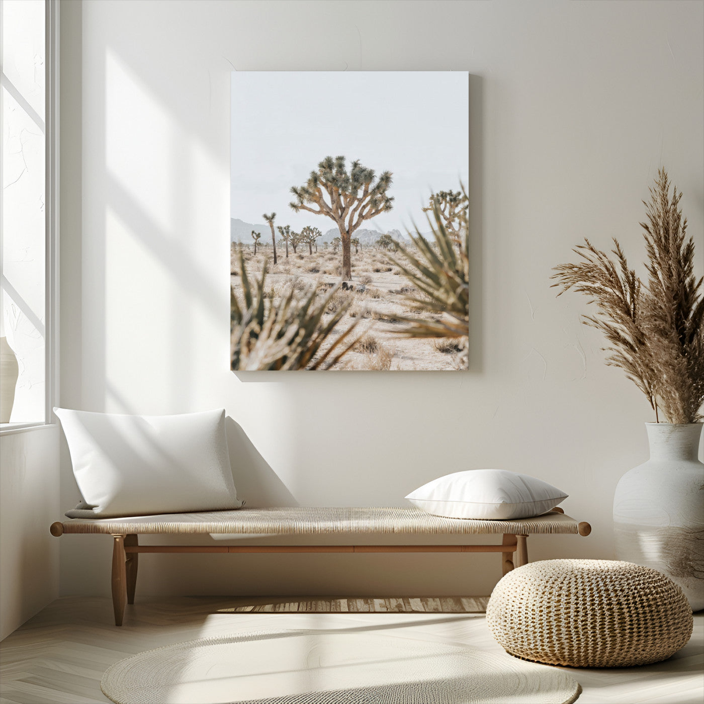 A wide desert landscape featuring multiple Joshua trees with spiky leaves and twisted branches, set against a pale sky and distant rocky hills. The foreground has blurred desert shrubs, emphasizing depth.