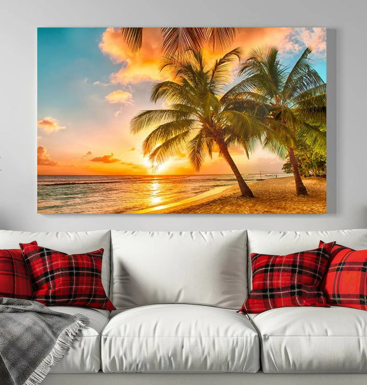 The Tropical Sunset Wall Art Print features a vibrant beach scene with palm trees and an ocean view highlighted by a golden sunset.