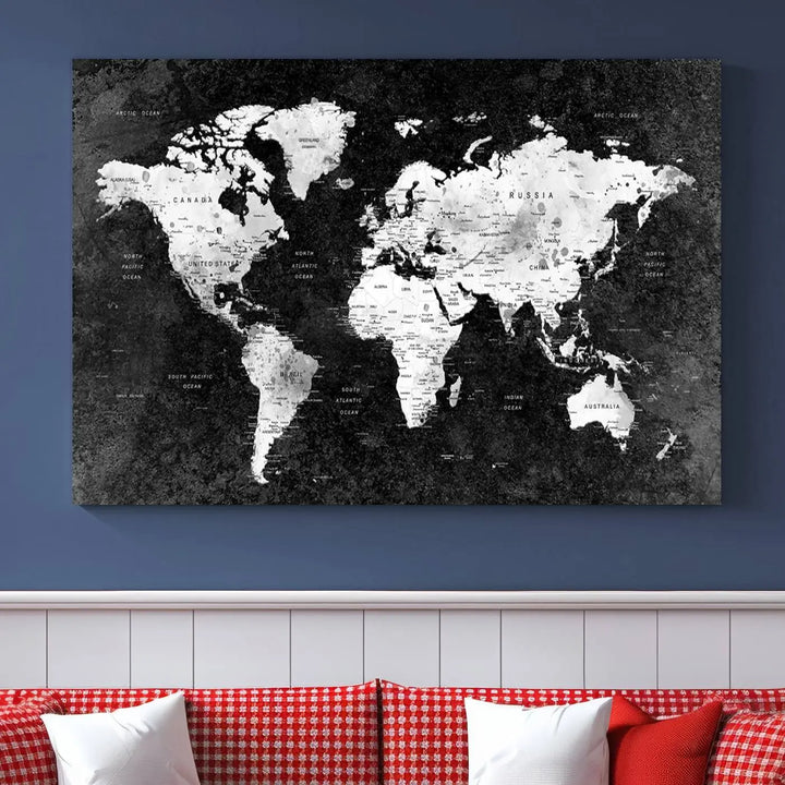 The Modern Grayscale World Map 3-Panel Canvas Art, ready to hang and framed, stylishly adorns the space above the sofa in a contemporary living room. It complements the minimalist décor with its black and white tones.