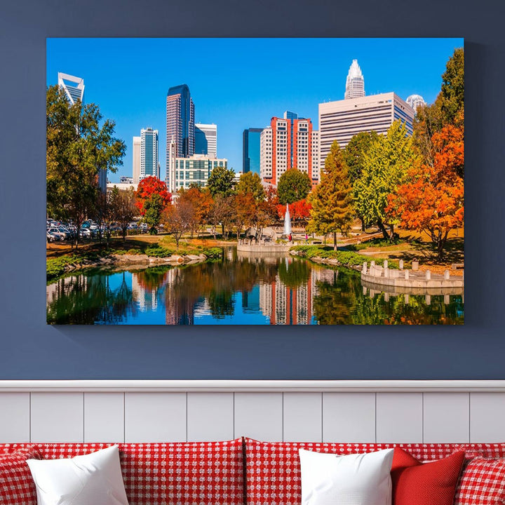 The Charlotte City Park at Fall Skyline Cityscape View wall art canvas print features a city panorama with a park and lake accented by autumn trees. It is mounted on museum-quality canvas with UV-protective coating and decorates the space.