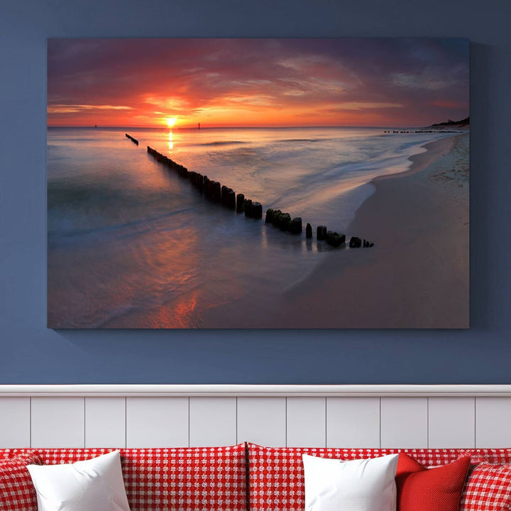 In a modern living room, the Sunset Beach Wall Art Canvas Print is displayed above. This triptych, printed on museum-quality canvas with a UV-protective coating, ensures lasting brilliance. It's ready to hang and brings an elegant touch to your space.