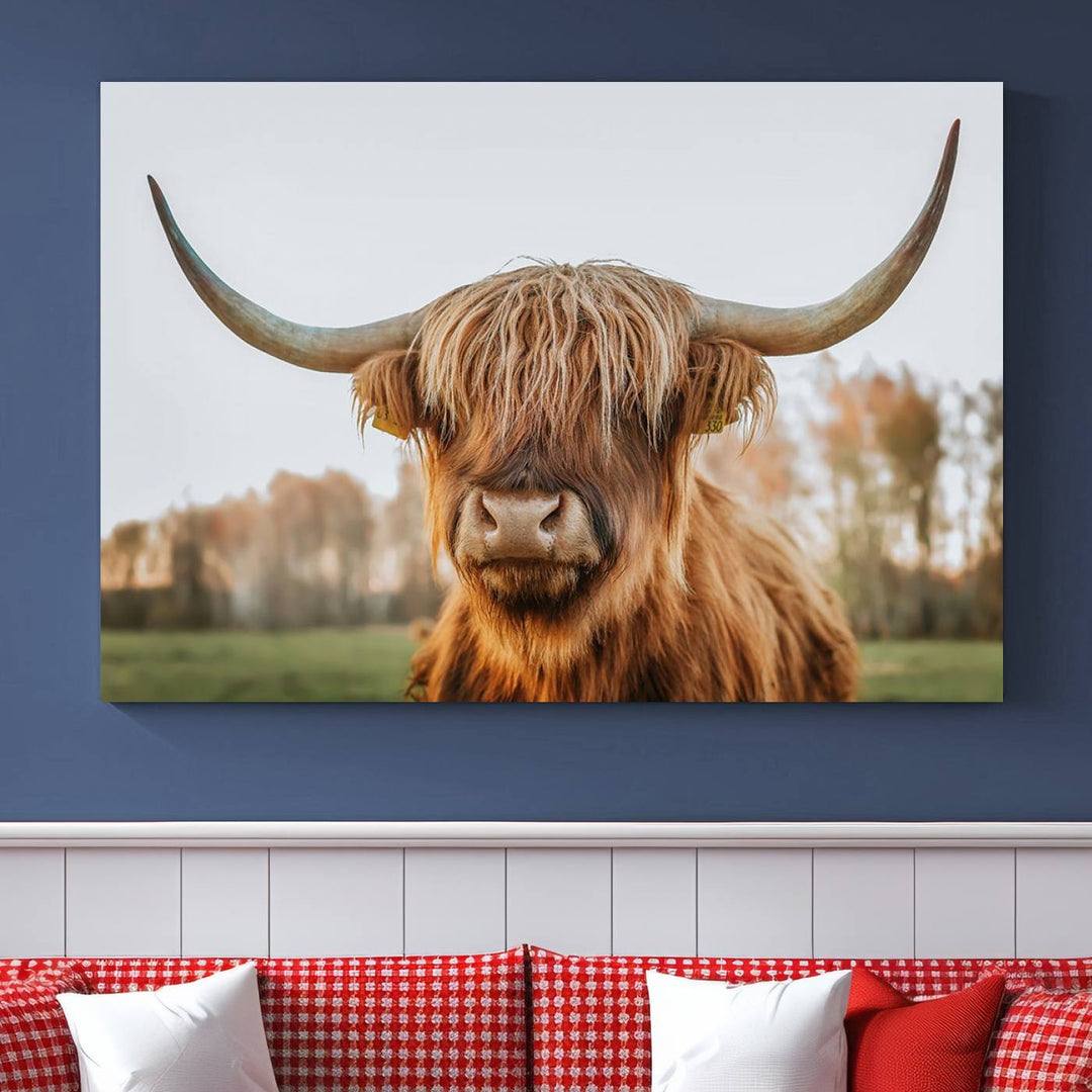 A Highland Cow Animal Scottish Cattle Art Print Farmhouse Wall Art Canvas Print hangs in the living room, adding a touch of rustic farmhouse decor.