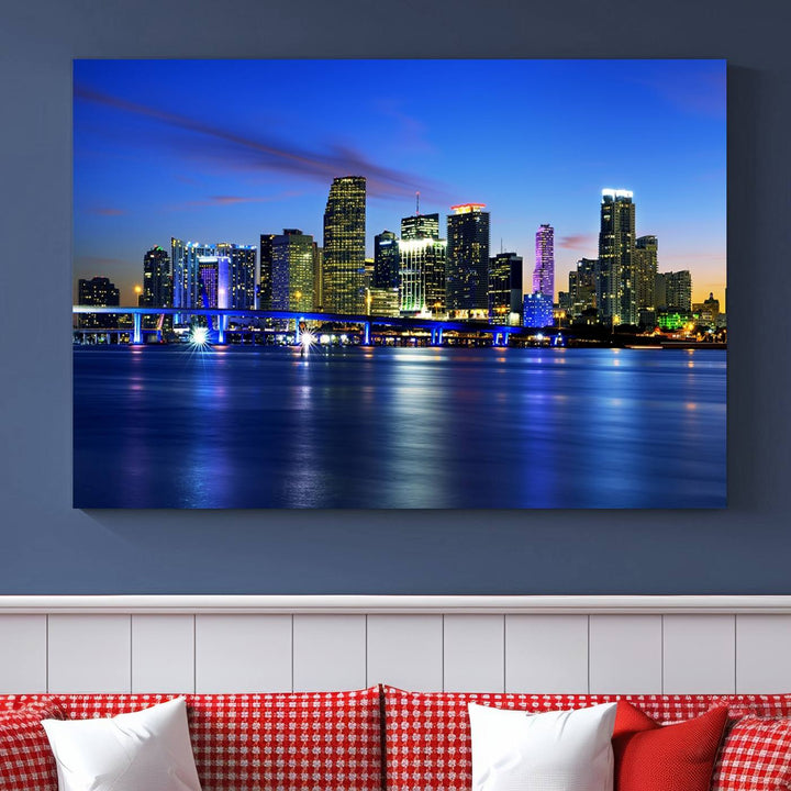 The modern living room showcases a striking Miami Blue Night Wall Art canvas print on the wall. The artwork is gallery wrapped on museum-quality canvas, ensuring durability and elegance.