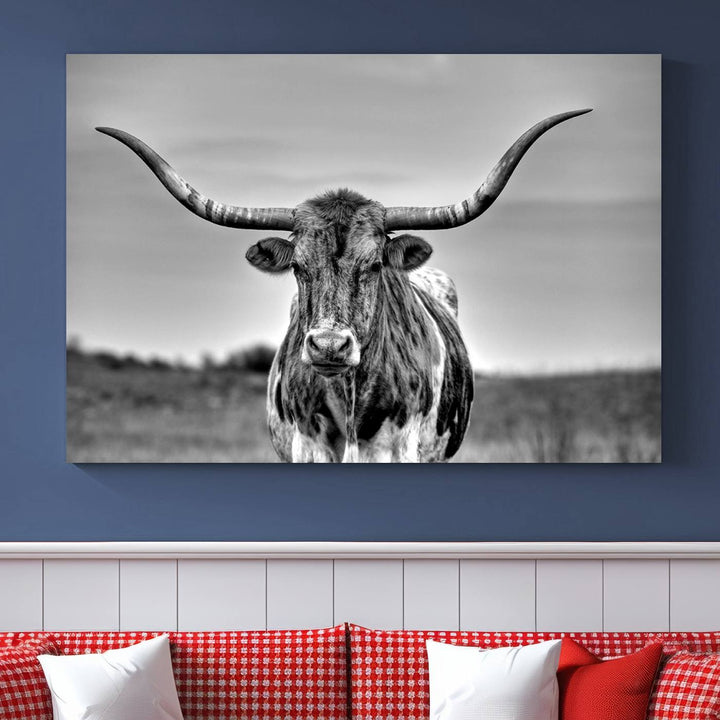 The Texas Longhorn Cow Wall Art, featuring a black and white image of a longhorn bull on canvas, brings charm to the room with its sophisticated appeal.