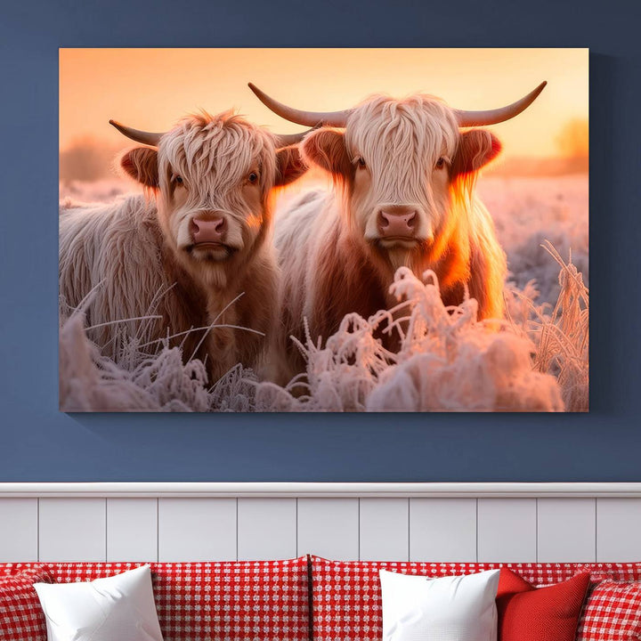 The "Highland Cows at Sunrise Wall Art Canvas Set" beautifully captures a serene and rustic farmhouse aesthetic, portraying two Highland cows in a frosty landscape at sunrise.