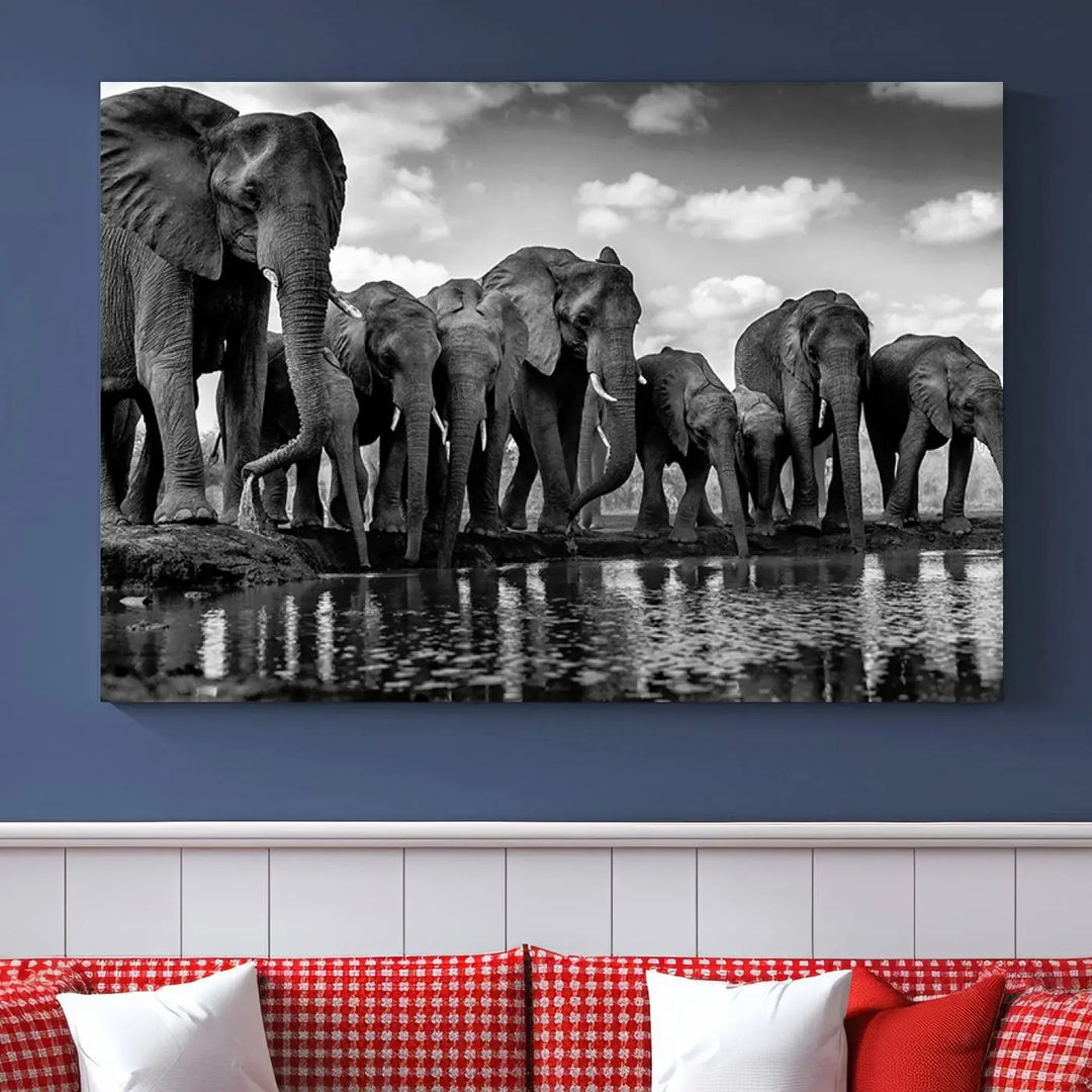 A stunning "Wall Art Animal Canvas Print" featuring a black and white photo of a herd of elephants drinking water is elegantly displayed, gallery wrapped on museum-quality canvas.