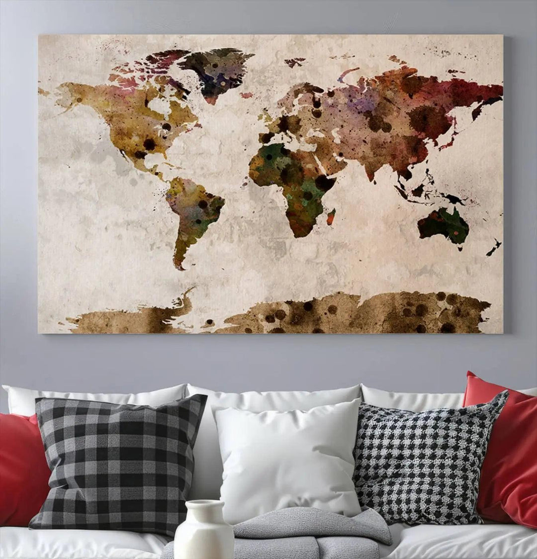 A Watercolor World Map Canvas Print, wrapped in an elegant gallery style, hangs on the wall.