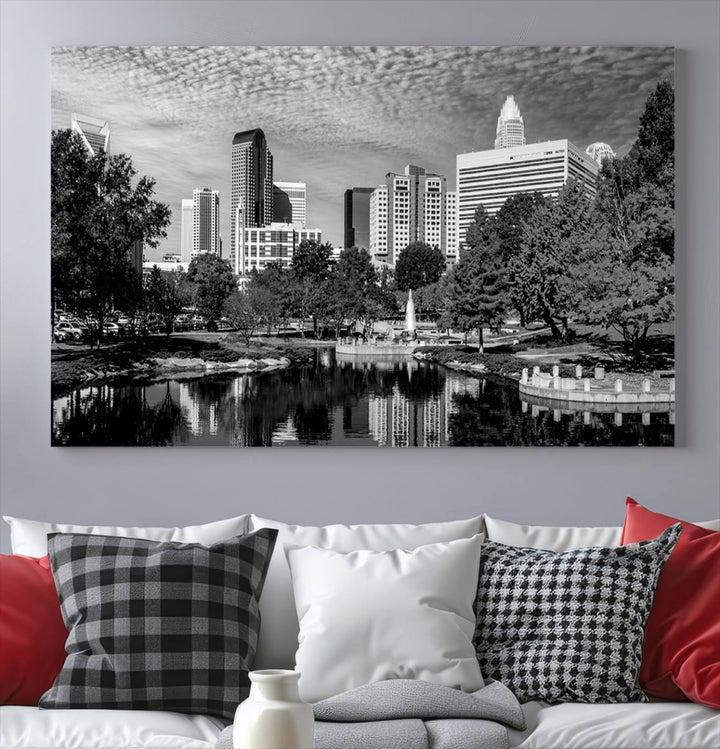 The living room features a captivating triptych titled "Charlotte City Cloudy Skyline Black and White Wall Art Cityscape Canvas Print," crafted on museum-quality canvas with UV-protective coating. Modern decor accentuates the dynamic scene.