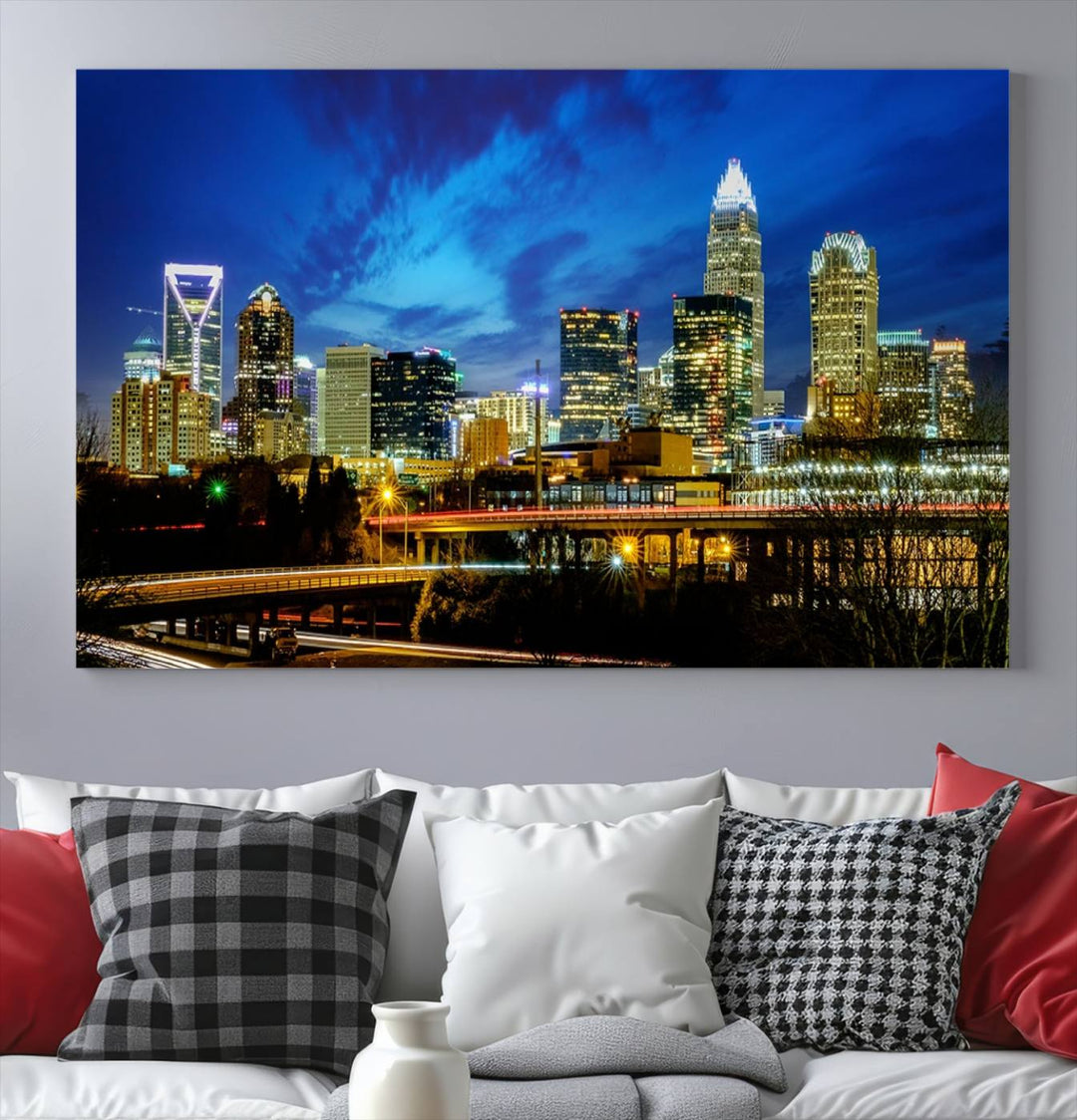 A modern living room highlighted by the "Charlotte City Lights Cloudy Blue Night Skyline Cityscape View" wall art canvas print, crafted on museum-quality canvas with UV-protective coating.