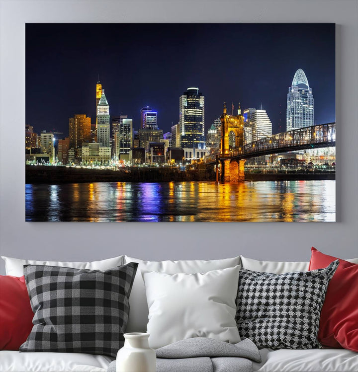 The Cincinnati City Lights Night Skyline Cityscape View Wall Art Canvas Print, crafted on museum-quality canvas with UV-protective coating and ready to hang, adds a touch of sophistication to the wall.