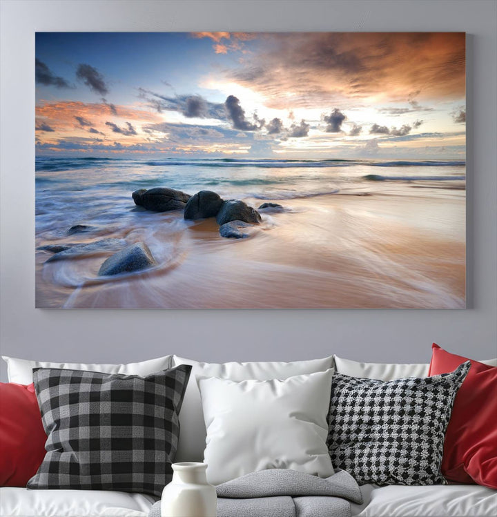 The "Serene Weather On The Beach Wall Art Canvas Print," featuring a tranquil beach scene with rocks and waves, is ready to hang and enjoy.