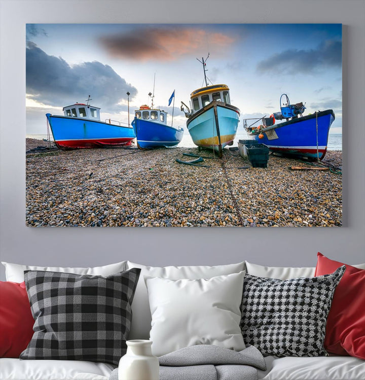 The "Big Boats On The Beach Wall Art Canvas Print" is a stunning piece featuring three museum-quality panels depicting fishing boats on a pebbled shore. Ready to hang and featuring UV-protective coating, it serves as an elegant addition to your home décor.