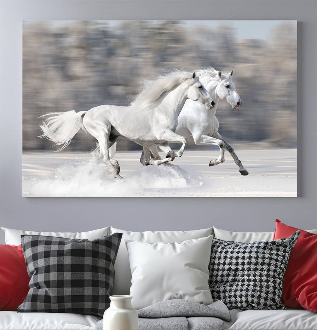 The "All The White Horses Wall Art Canvas Print" depicts a triptych of galloping white horses across a snowy landscape. These museum-quality canvases come with a UV-protective coating to maintain their stunning appearance over time.