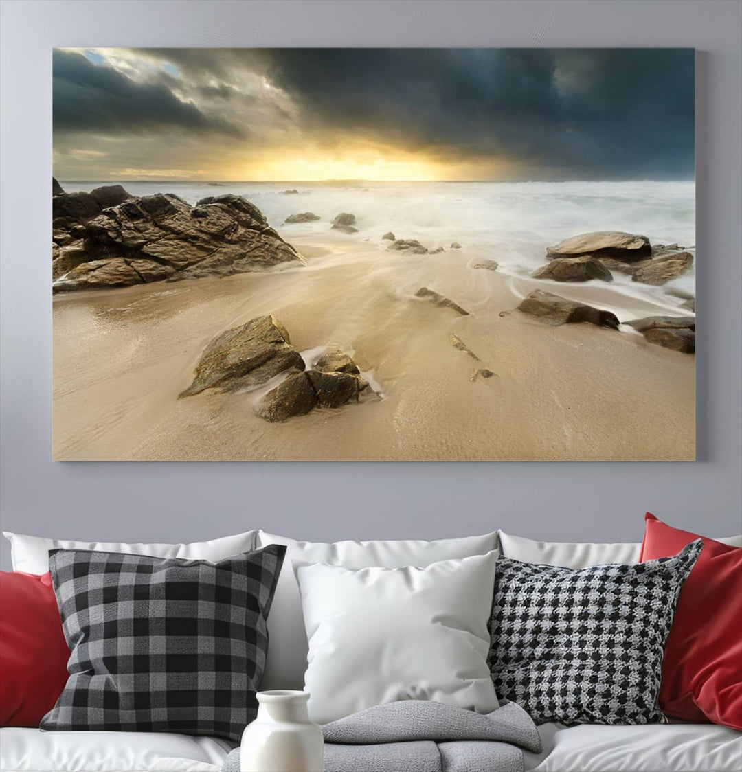 A gallery-wrapped, three-panel artwork titled "Rocks and Waves Wall Art Canvas Print" depicts a rocky beach at sunset. Each canvas showcases museum-quality craftsmanship and a UV-protective coating to maintain its vibrant colors.