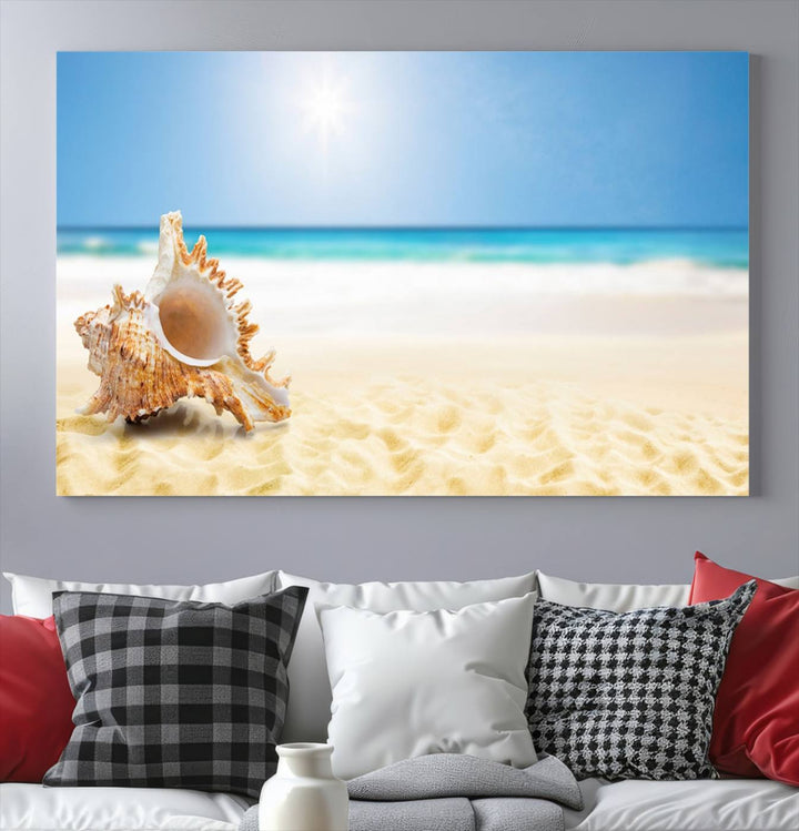 The Sea Shell on The Beach Sun Sand Wall Art Canvas Print is a triptych that beautifully captures a beach scene with a large seashell on the sand.